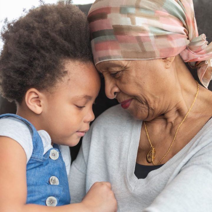 Senior woman with cancer hugging her grandchild