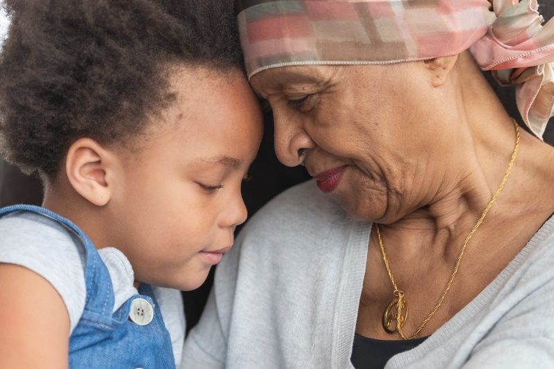 Palliative Care Senior woman with cancer hugging her grandchild