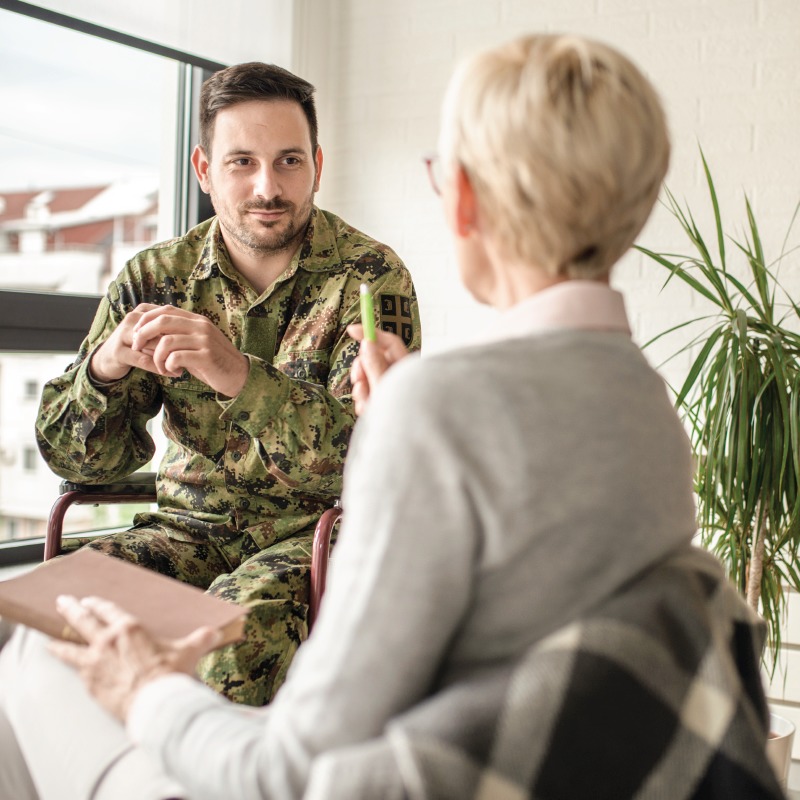 Male military veteran in therapy session with female psychologist